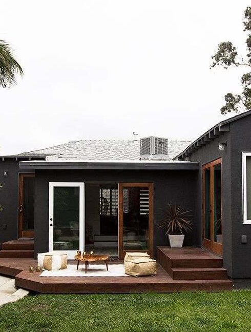 A black house with wooden decking