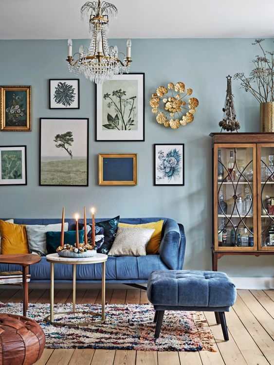 A white crystal and chandelier and blue sofa and blue living room