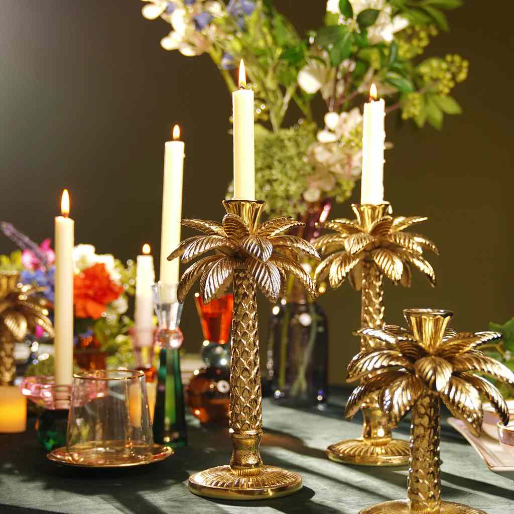 Gold candle holders for warm and glass on it
