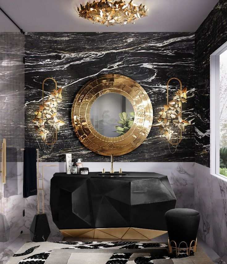 A bathroom with gold mirror and black bathtub