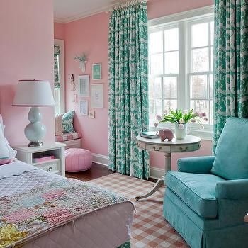 A pink bedroom with sofa and side table on the lamp