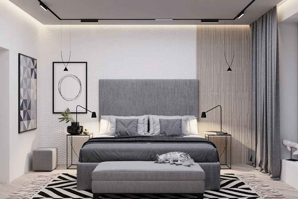 A white bedroom with grey bed and white and black rug on the floor 