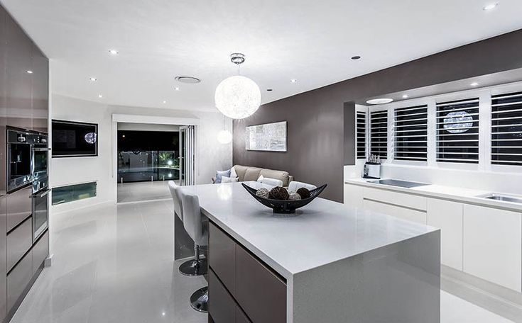 Grey kitchen with white and black room and round light above the wall