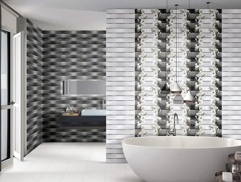 A grey bathroom tiles and white bathtub