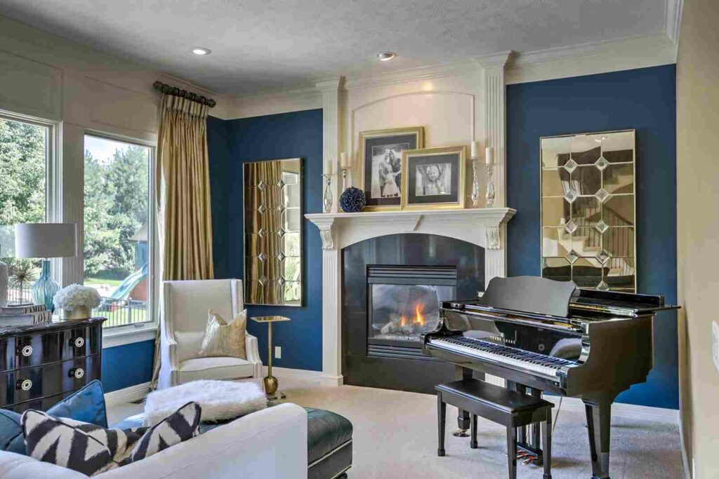 A grey fire place and white and blue living room and grey piano