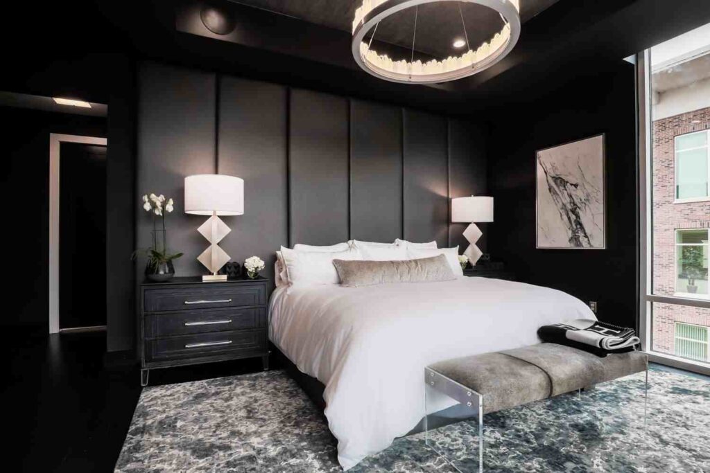 Hanging artwork in white and black bedroom 
