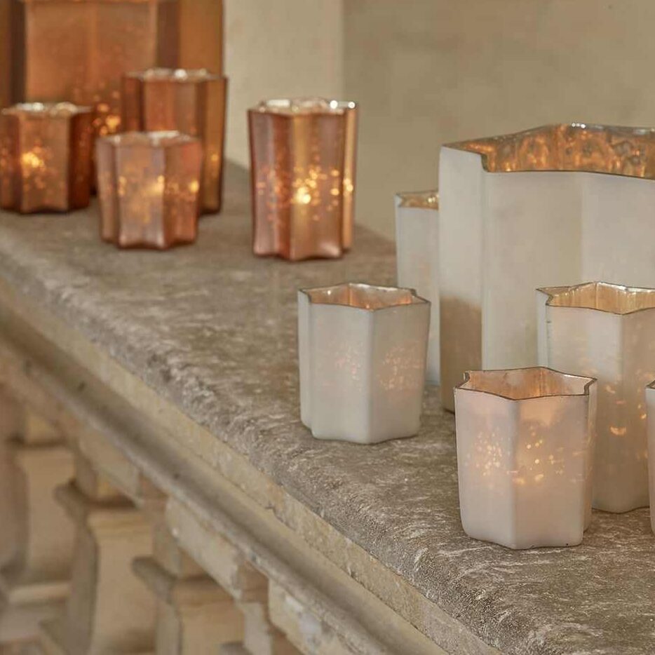 A rose-gold candles on the table