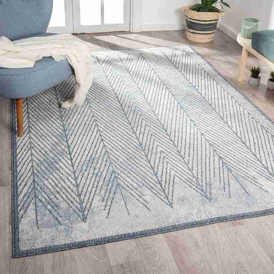 A wooden floor with Blue and grey chevron rug