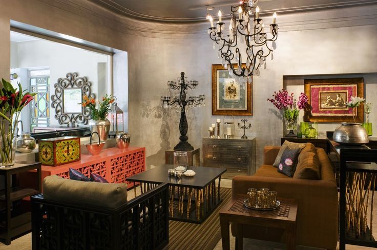 A brown living room with brass fixture and sofa with table and side table