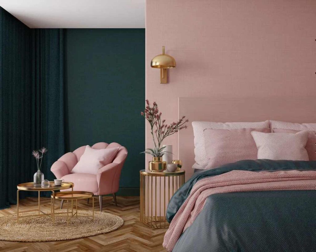 A white and green room with bed and pink pillow and pink chair and side table 