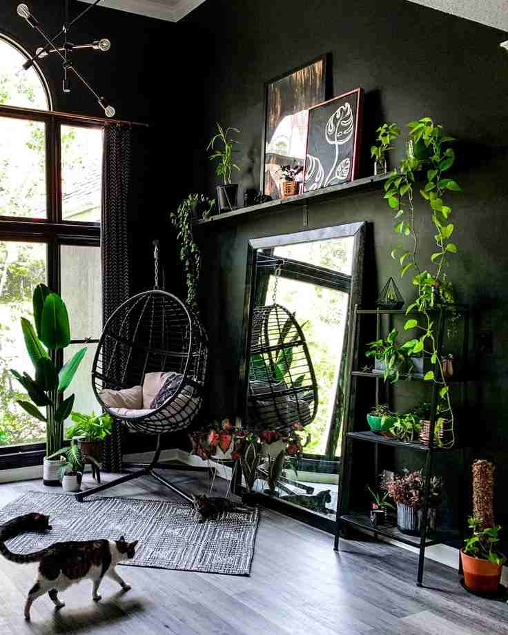 A black living room with mirror and mat on the floor
