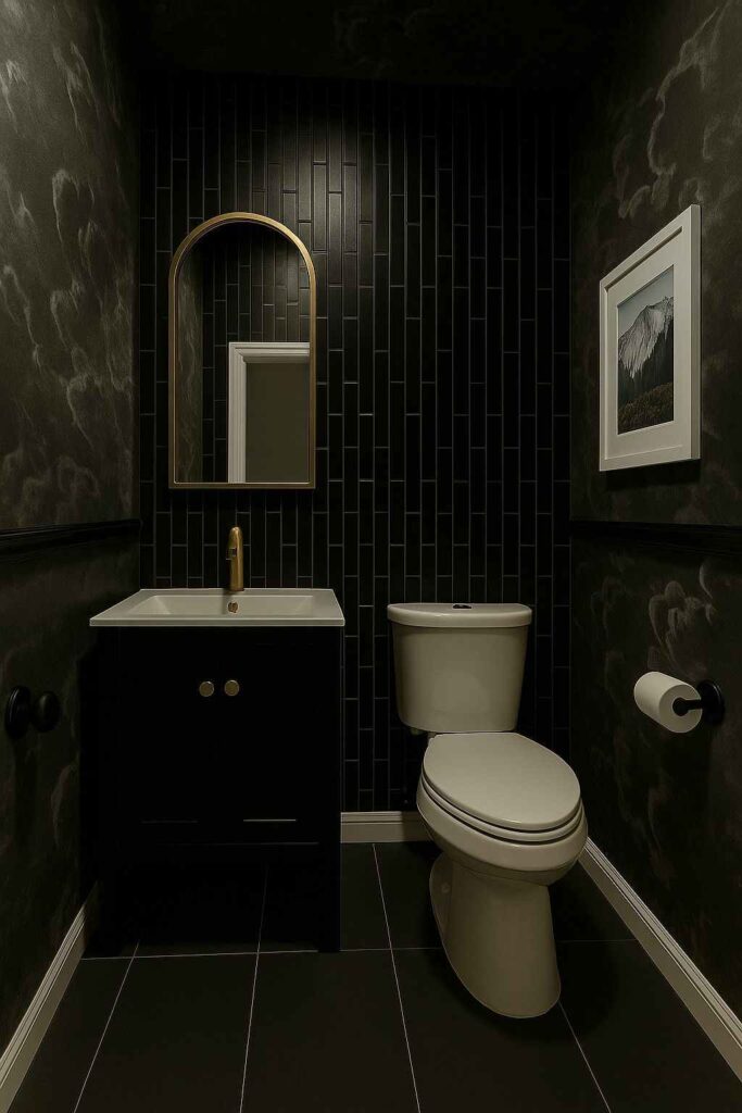 A black bathroom with white toilet and gold accents