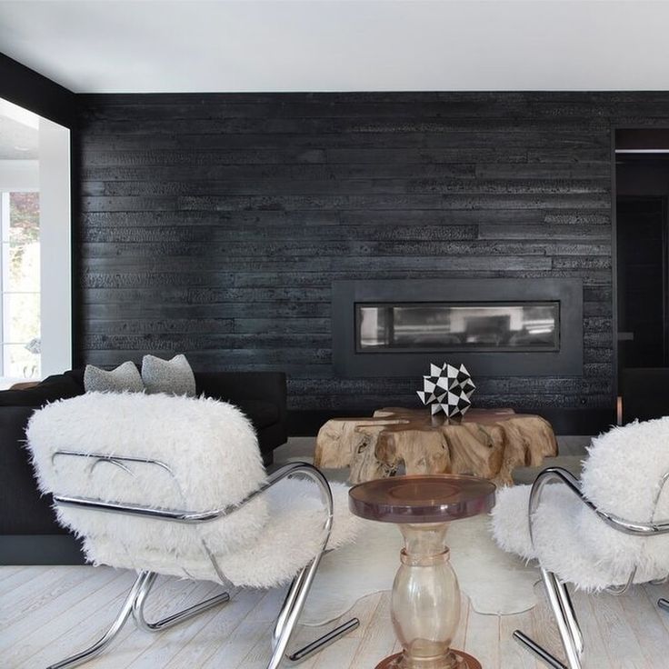 A black wall with white chair and table 