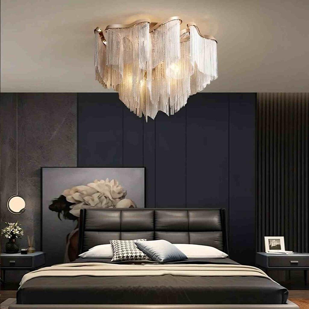 A black bedroom with metallic fixture and side table 