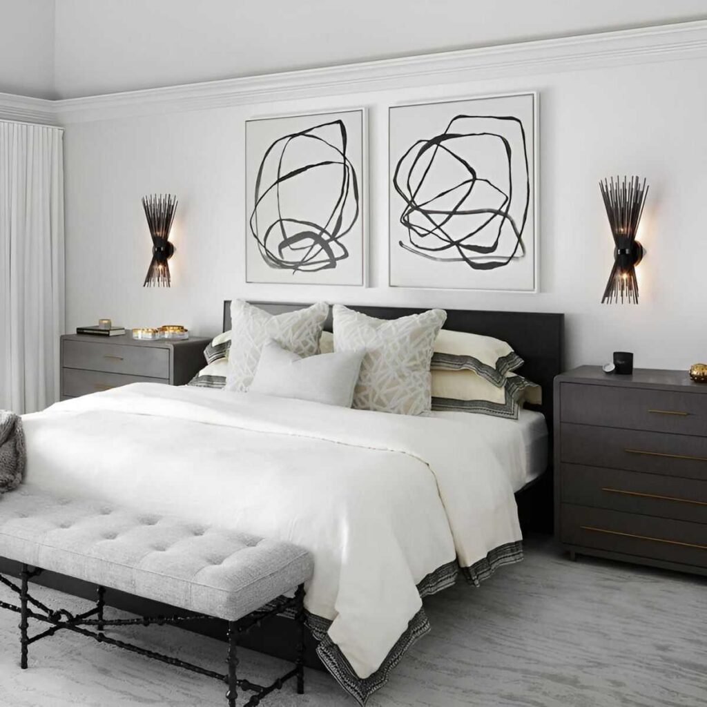 A white bedroom with black side table and lights on the wall 