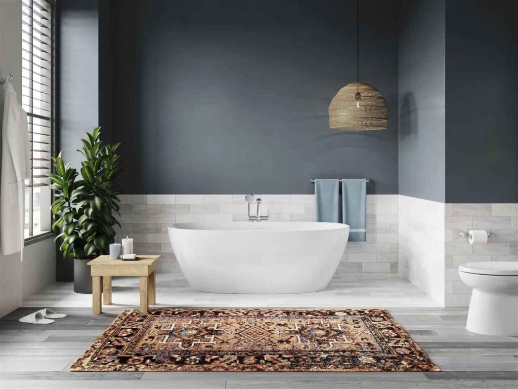 A grey white bathroom with white bathtub and table o the floor 