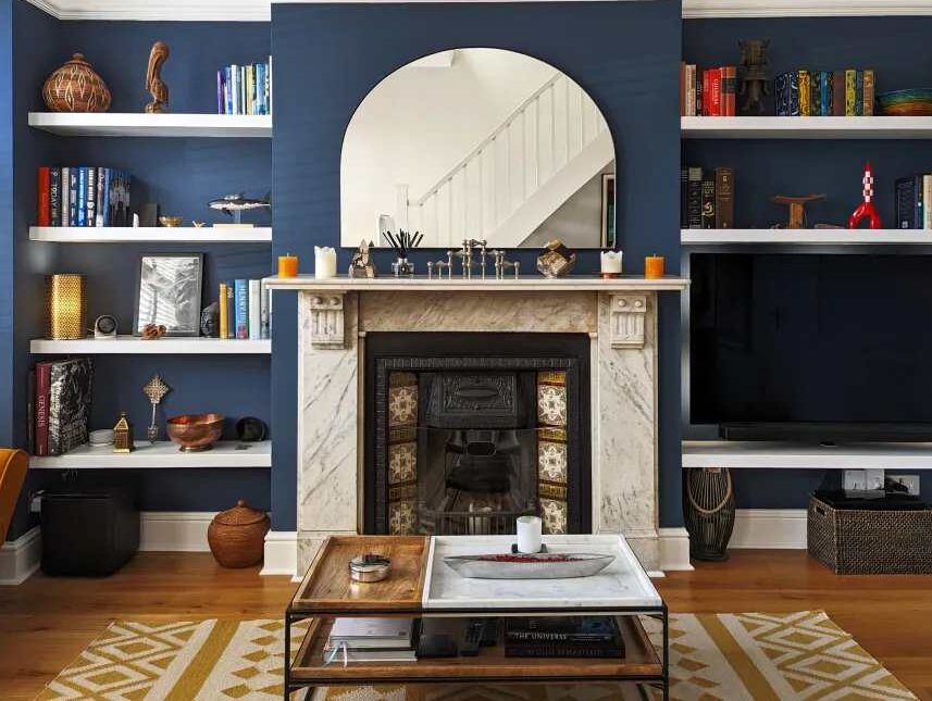 A white shelves in blue living room and table