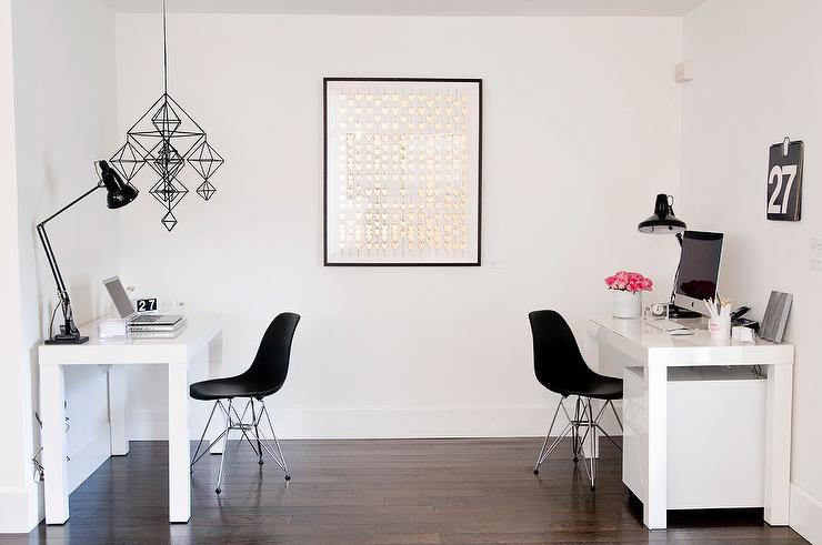 White desk with black chair and study lamp on the desk 