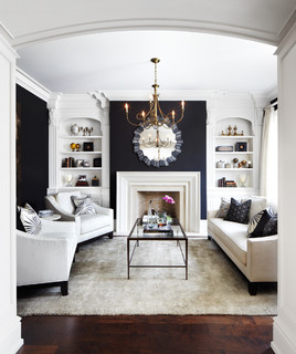 A white and black living room and sofas and mat on the floor