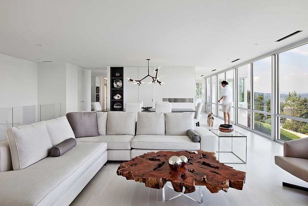 White living room with wooden table and white sofa and cushion