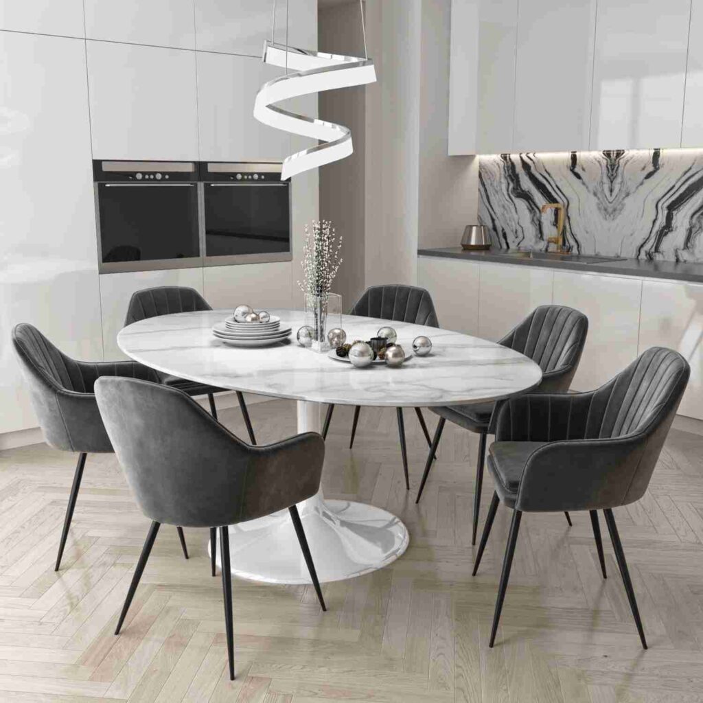 A white marble table with grey chairs 