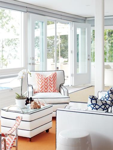 A white living room and sofa with black piping with table