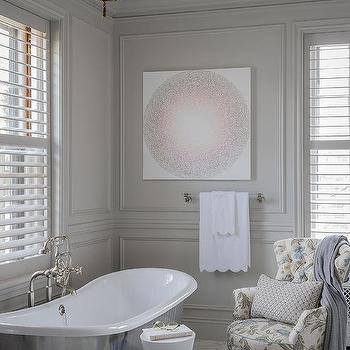 A white trim windows on grey bathroom with white tub