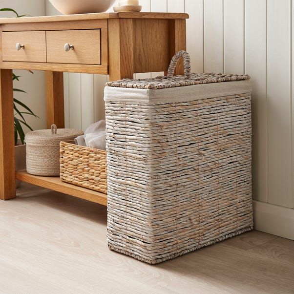 A woven rattan baskets in bathroom with wooden vanity 