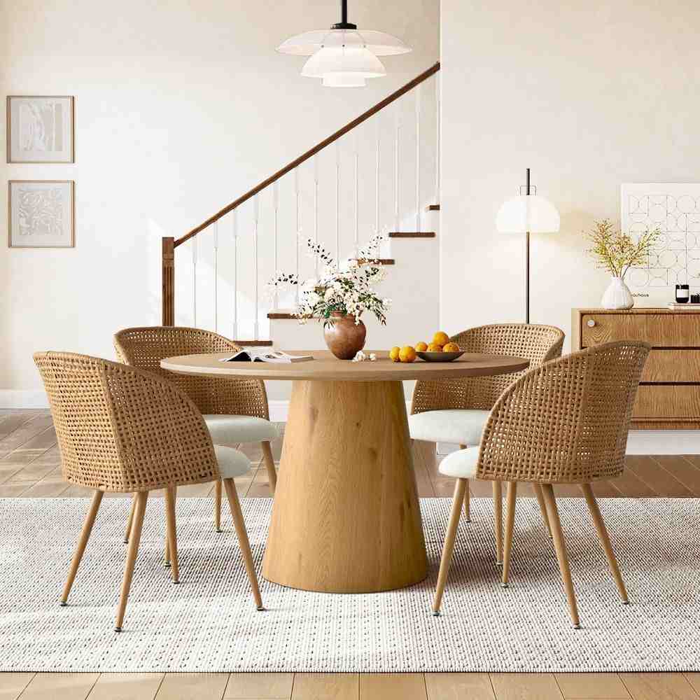 A wooden rattan chairs and table and mat on the floor