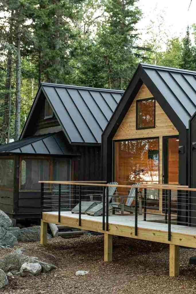 A black house with cedar balcony and glass windows