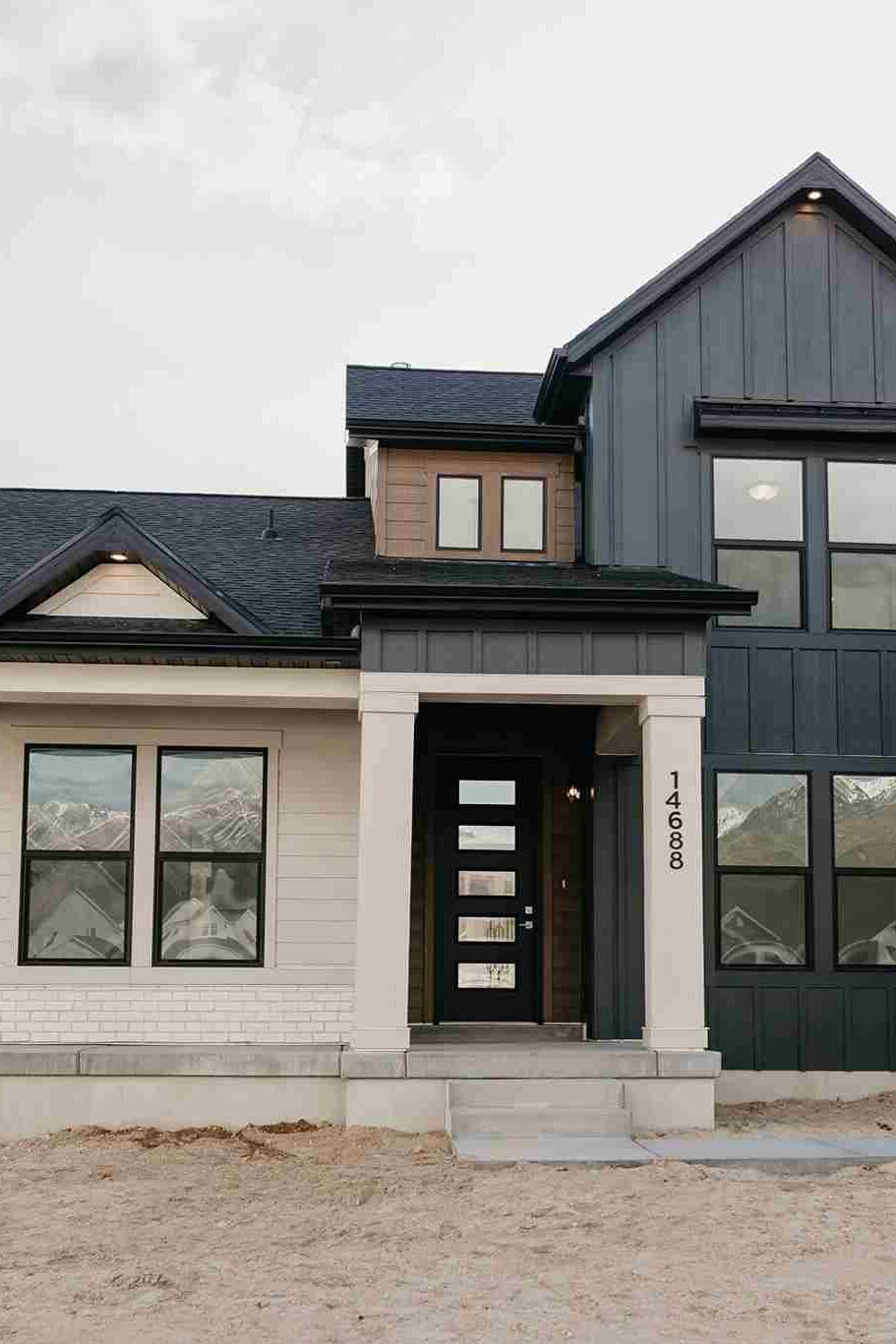 A white and black house with glass windows