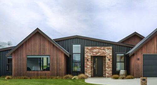 A black house with brick entryway and cedar sidling and glass windows