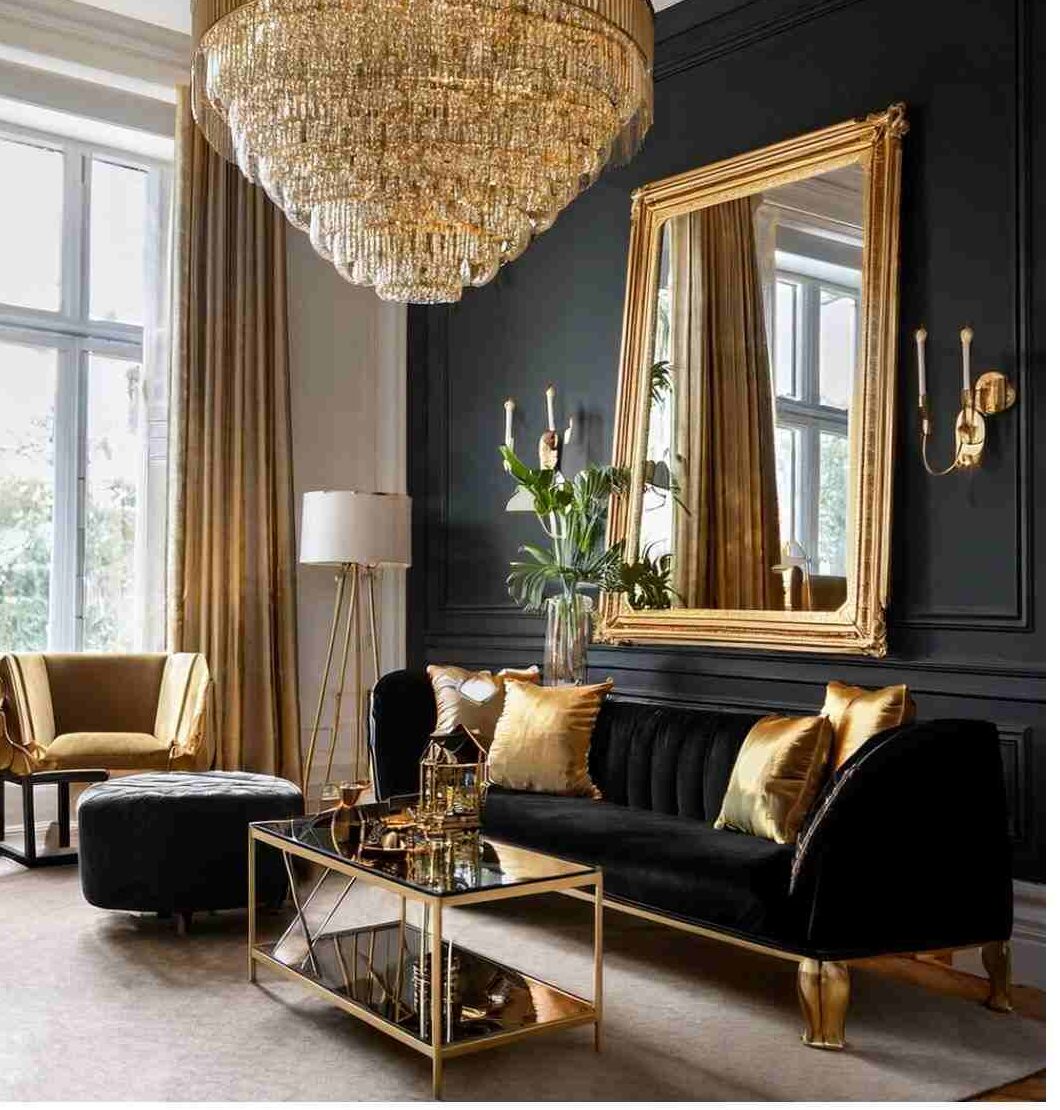 A black living room with black sofa with gold cushion and glass table