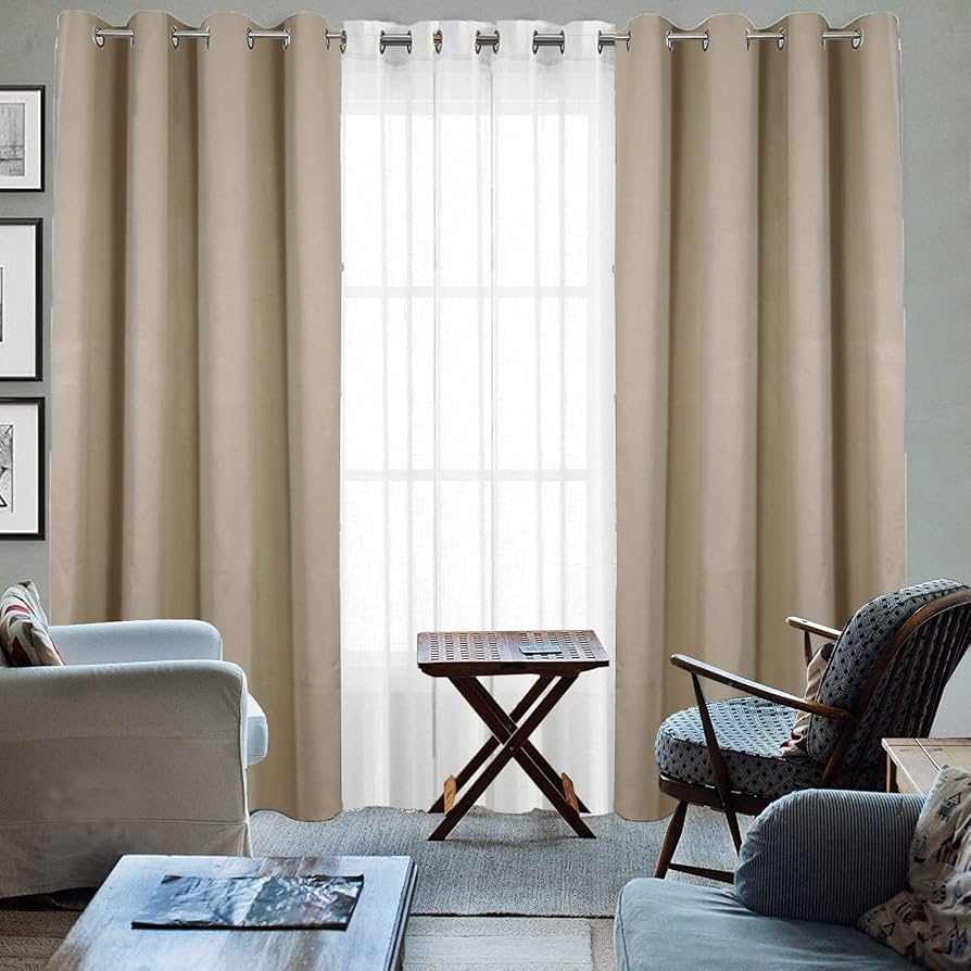 A grey living room with beige curtains and chair and table