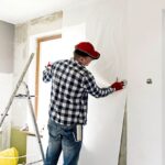 a person fixing the wall