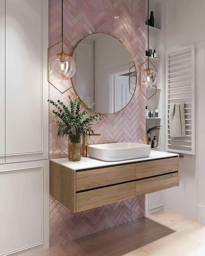 A white and grey bathroom with pink accents and white sink 