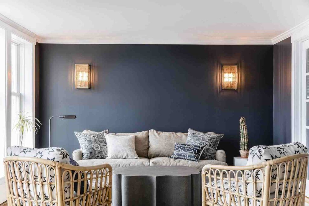 A blue living room with Wooden sconces and chair 