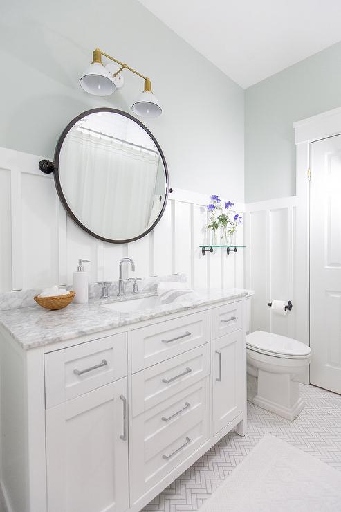 A white bathroom and mirror on the wall and table