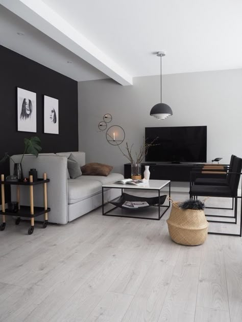 A wooden floor with grey living room and and sofa and wooden vase