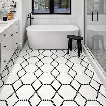 A bathroom with black and white tiles flooring and white bathtub 