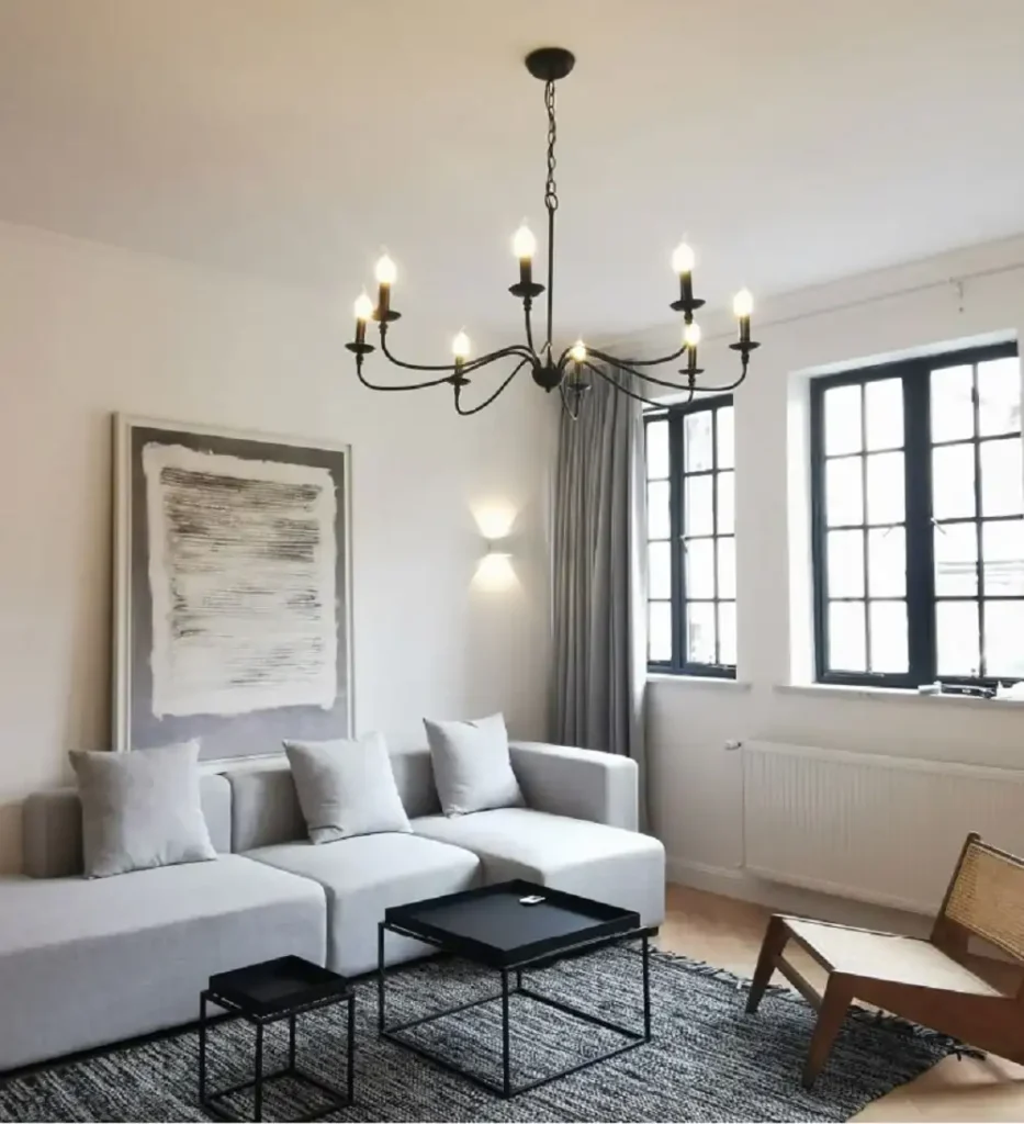 Black chandelier in grey living room and grey sofa with cushion 