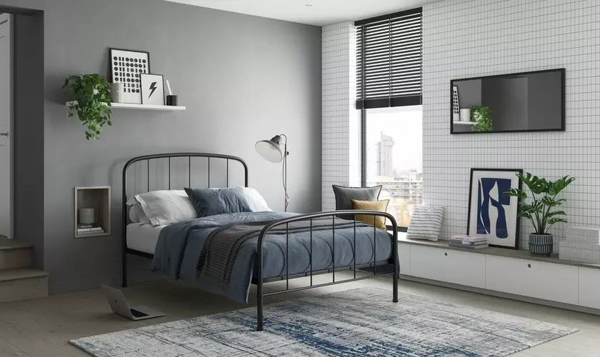 A grey bedroom with black bed metallic 