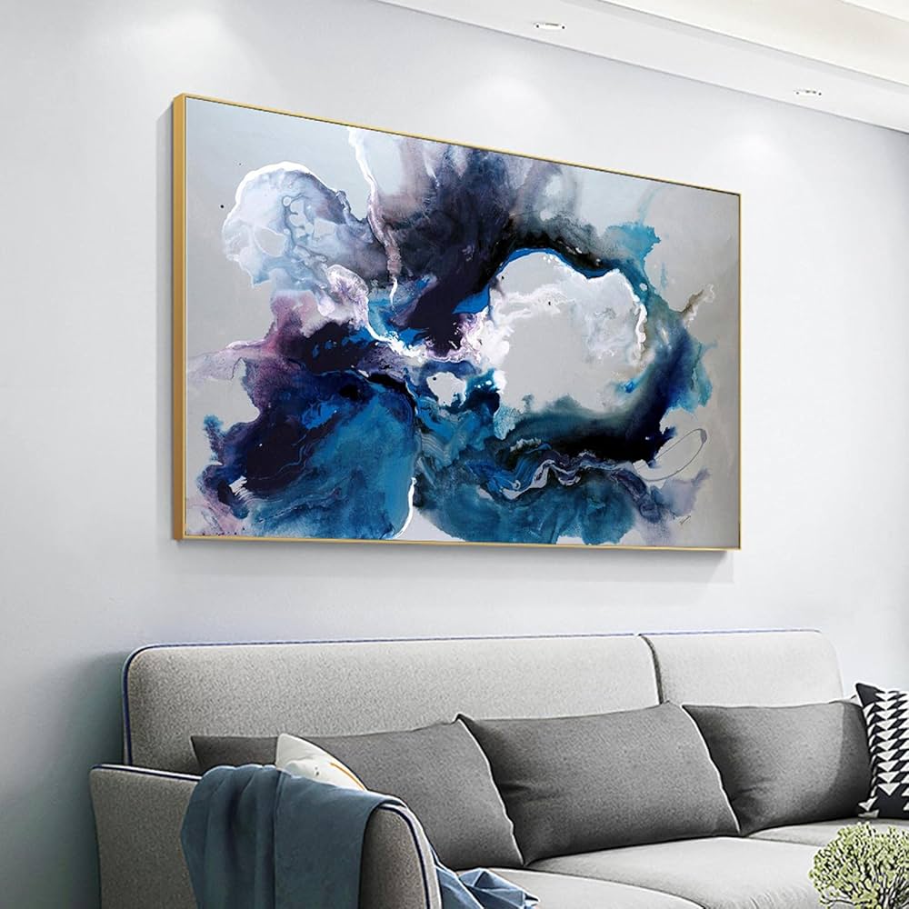 A grey living room with grey and blue artwork on the wall 