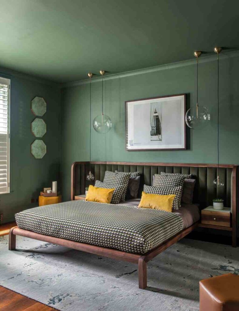 A sage green bedroom with wooden bed and floor and light fixture 