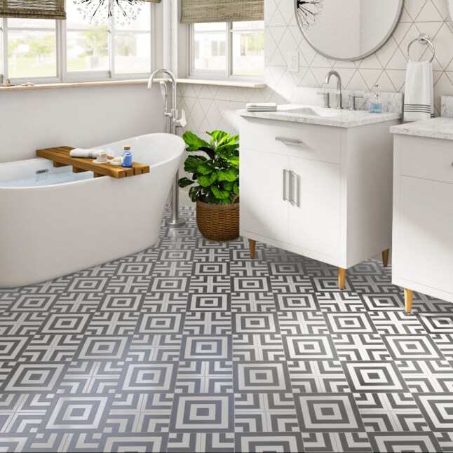 A bathroom with tiles and white bathtub and white vanity and mirror on the wall 