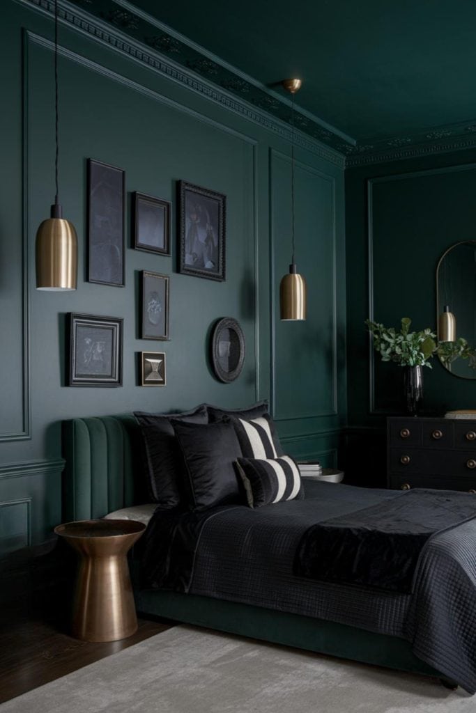 A green accent wall and black painting on the wall and gold accents 