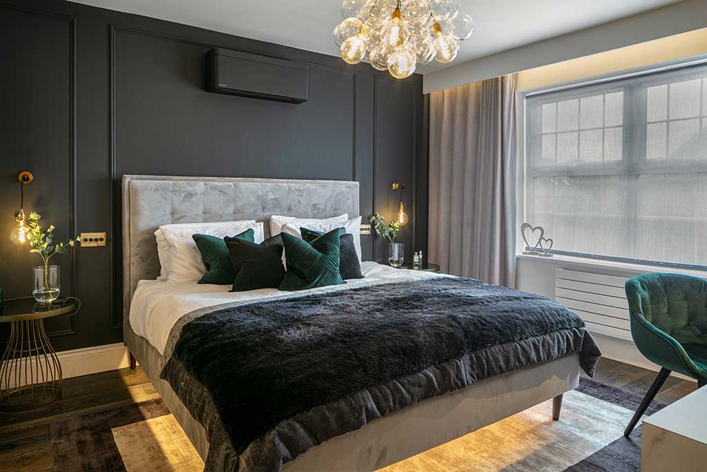 A green and grey bedroom with lights and curtain and windows 