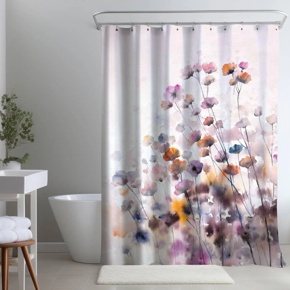 A grey bathroom with floral  curtain and white bathtub 