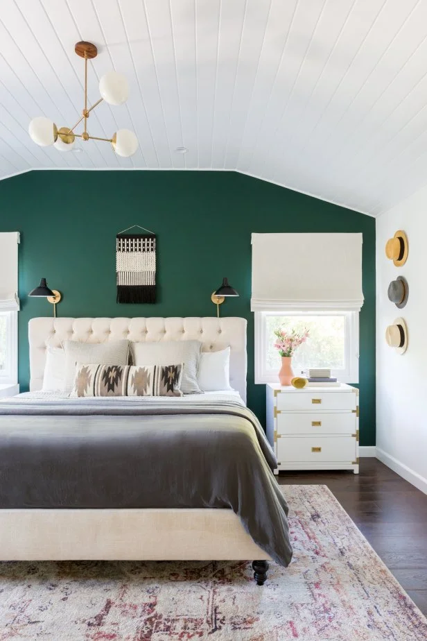 A green bedroom with white celling and windows 