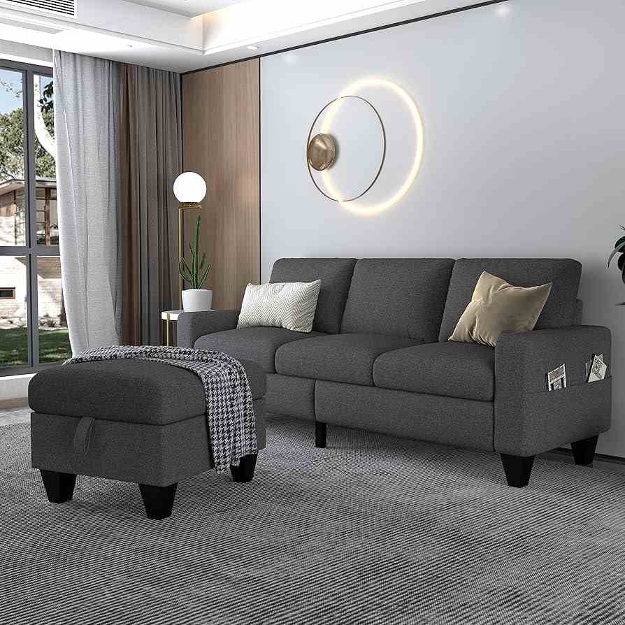 A grey living room with ottoman throw on it 